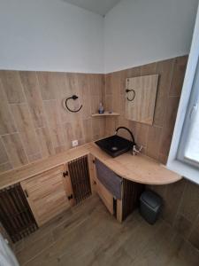 a small room with a wooden table and a sink at Ilūkstes Sauna apartamenti (bezkontakta) in Ilūkste