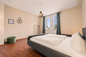 a bedroom with a large bed and a window at Wohnen bei der alten Dampflok inkl. Balkon in Meckenbeuren