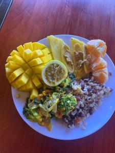 a plate of food with rice and vegetables and fruit at Chorotega Cabina in Monteverde Costa Rica