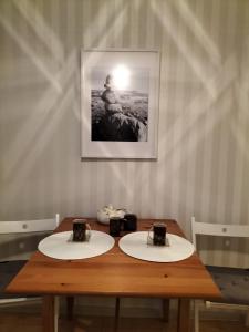 a wooden table with two plates on top of it at Stacja Kocham Morze in Gdańsk