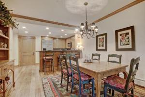 a dining room and kitchen with a table and chairs at Settler's Lodge 204 in Edwards