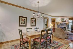 a dining room with a wooden table and chairs at Settler's Lodge 204 in Edwards