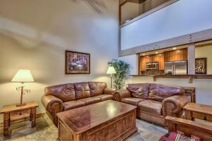 a living room with leather couches and a table at 511 Pine Grove in South Lake Tahoe