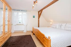 a bedroom with a wooden bed and a window at Ferienwohnung Fortuna II in Thiessow