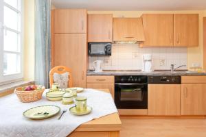 a kitchen with a table with dishes on it at Ferienwohnung Fortuna II in Thiessow