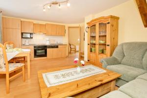 a living room with a couch and a table at Ferienwohnung Fortuna II in Thiessow