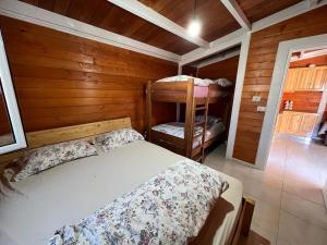 a bedroom with a bed and two bunk beds at Baven -Toven Naturae in Rubik