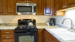 a kitchen with a stove and a microwave at Ski Trails 4024 in Truckee