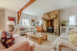 a living room with a couch and a fireplace at Owl Barn in Aston