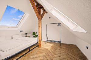 Habitación blanca con cama y ventana en Maisonette-Wohnung mit freigelegtem Fachwerk, en Meckenbeuren