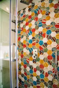 a bathroom with a mosaic tile wall in a shower at A terrace on the sea in Maiori