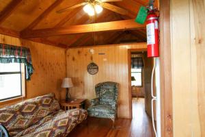 a living room with a couch and a chair at Lakeview Cedar Cabin - 7 in Mead