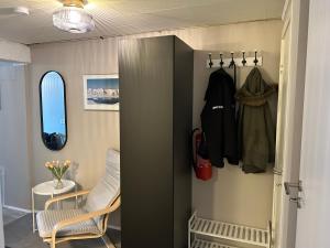 a room with a closet with a chair and a table at The Painter's house in Siglufjörður