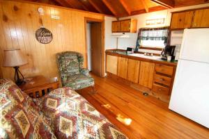 a room with a kitchen and a living room at Lakefront Cedar Cabin - 8 in Mead