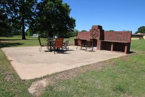 a group of chairs and tables in front of a building at Lakefront Cedar Cabin - 10 in Mead