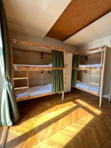 a room with three bunk beds in it at Cabbage Hostel in Belgrade