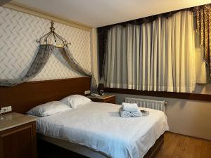 a bedroom with a bed and a large window at Grand Peninsula Hotel in Istanbul