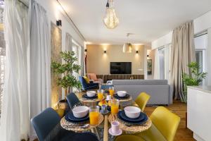 a dining room with a table and yellow chairs at WHome | Ribeira 11 Design Apartment in Lisbon