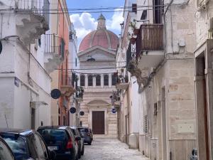 a building with a dome on top of a street at Casa Dante - Holiday House in Fasano