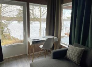 a room with a desk and a table and a window at Fantastic holiday home with own lake plot by Bolmen, Ljungby in Ljungby