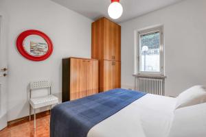 a bedroom with a bed and a cabinet and a window at Ciclamini 29 - Casa Casoni in Numana