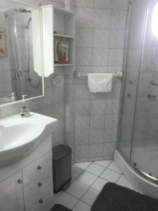 a white bathroom with a shower and a sink at Department la Serena Beach in La Serena +13 photos