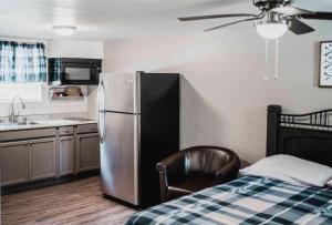 a kitchen with a refrigerator and a chair in a room at Lake Access Quad-plex Kitchenette - 29 in Mead