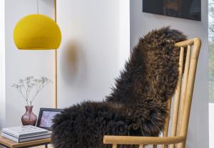 a furry chair with a table and a laptop at Slackbrae in Forest Mill