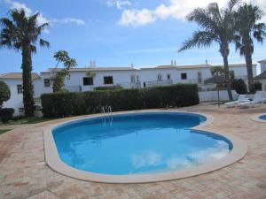 a large swimming pool in a yard with a building at Villa Figueira in Figueira