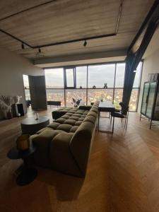 a large living room with a couch and a table at HOUSE38 Panoramic View Apartments SELF CHECK-IN in Kaunas