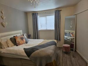 a bedroom with a large bed and a window at Albert Apartment with free Gym in Penzance
