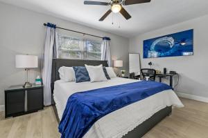 a bedroom with a bed and a ceiling fan at A Wave From It All in Largo