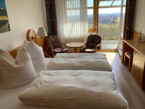 a hotel room with two beds and a balcony at Gasthaus Sonne in Hohenstadt