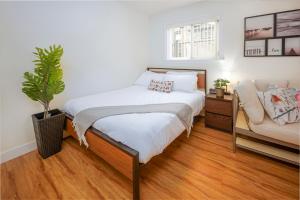 a bedroom with a bed and a couch at Cozy 2 beds Spacious rooms,Close to transit in Vancouver