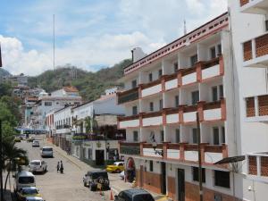 a view of a city street with cars parked at Caracol in Puerto Vallarta