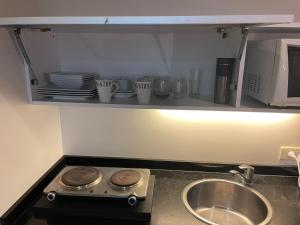 encimera de cocina con fregadero y microondas en Modern Loft in Buenos Aires down town en Buenos Aires