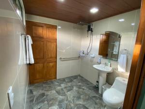 a bathroom with a toilet and a sink at Indigo Container House in San Luis