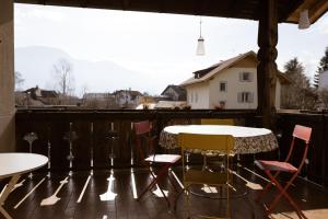 een patio met een tafel en stoelen op een balkon bij Schöne Wohnung am Stadtrand von Meran Valentinhof in Merano