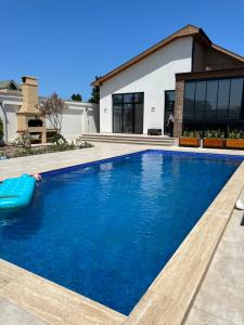 a swimming pool in front of a house at Family villa in Baku