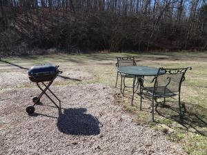 a grill and a table in a field at JI1, King Guest Room at the Joplin Inn at entrance to the resort Hotel Room in Mount Ida