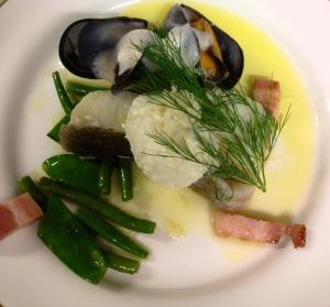 a plate of food with oysters and vegetables on it at Rågårdsvik in Grundsund