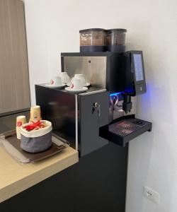 a kitchen with a coffee machine with dishes in it at Garni San Paolo in Appiano sulla Strada del Vino