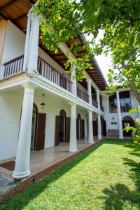 an image of a house with columns and grass at GALLE HERITAGE VILLA in Galle