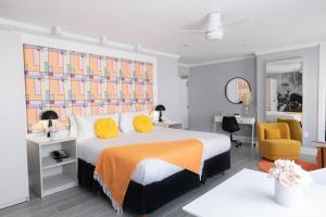 a bedroom with a large bed with yellow pillows at Fashion Boutique Hotel in Miami Beach
