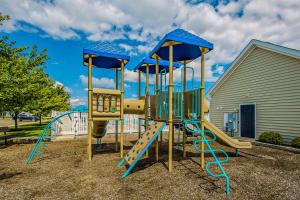 a playground with a slide in a yard at Grande at Canal Pointe - 37696 Ulster Dr, Unit #12 in Rehoboth Beach
