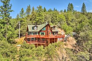 a large wooden house on a hill in the woods at Mountain Bliss Chalet with Great Views! in Sonora