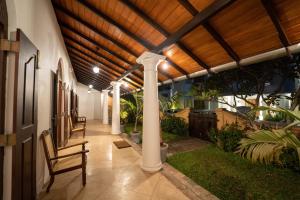 a porch with columns and a wooden ceiling at GALLE HERITAGE VILLA in Galle