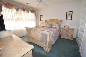 a bedroom with a bed and a dresser and a television at 613 River Crossing Condo in North Myrtle Beach