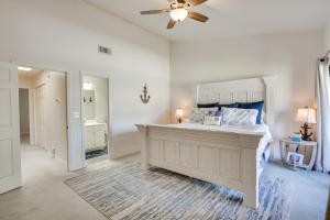 een slaapkamer met een bed en een plafondventilator bij Sun-Dappled PCB Retreat with Multiple Pools! in Panama City Beach +23 foto's