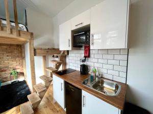 a small kitchen with a sink and a staircase at Flat 14, 10 St John’s in Bournemouth